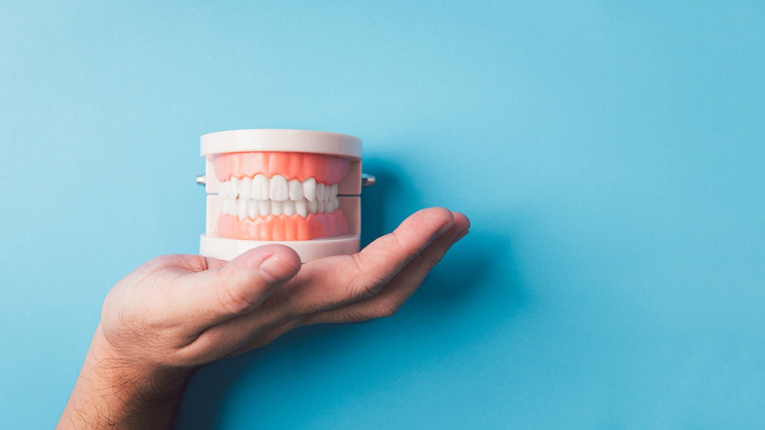 hand showing teeth gum jaw plasti
