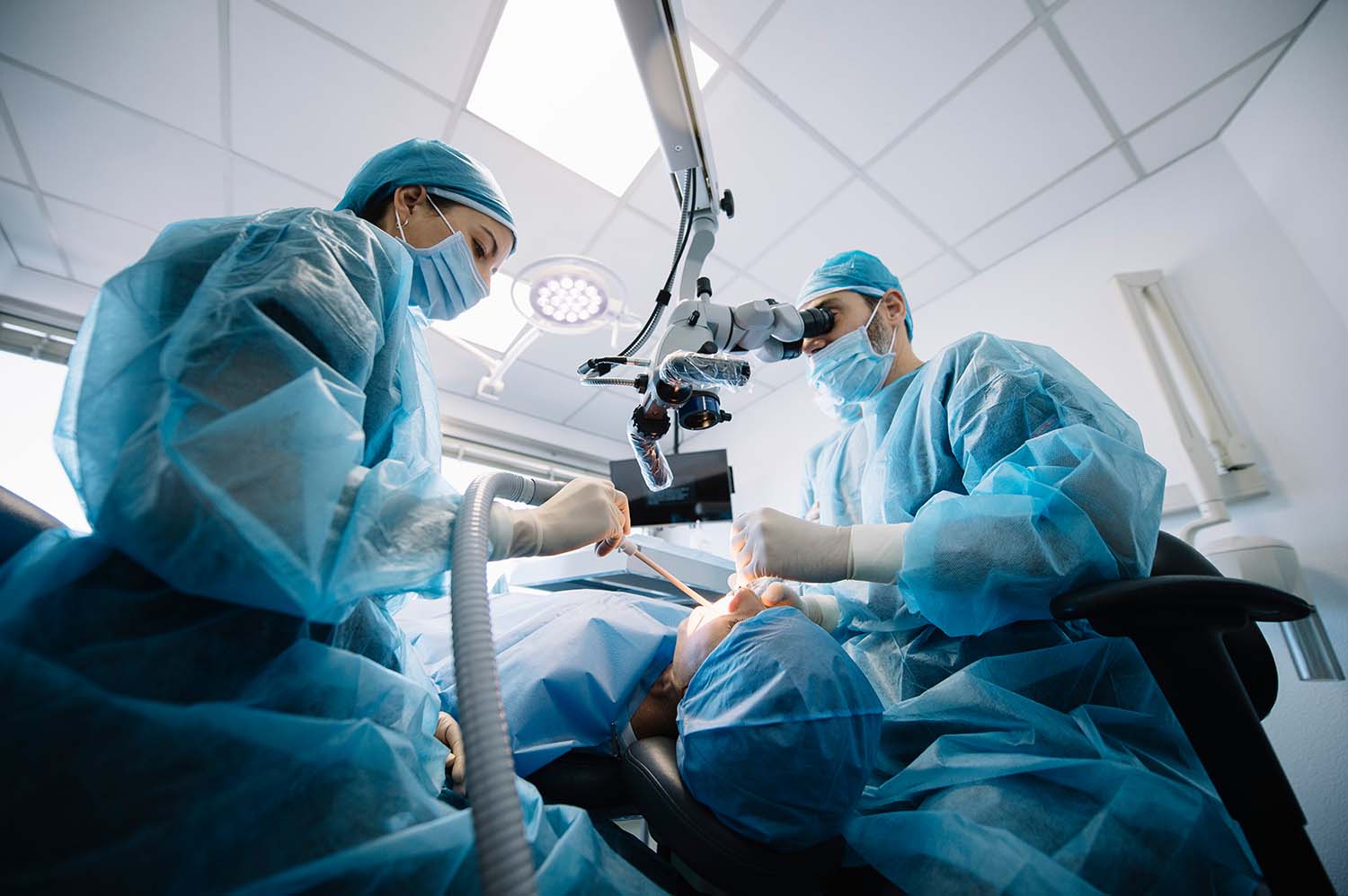 dentist during dental intervention patient clinic
