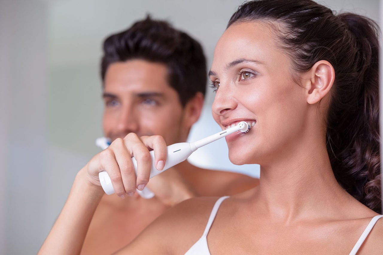 attractive couple brushing their teeth morning