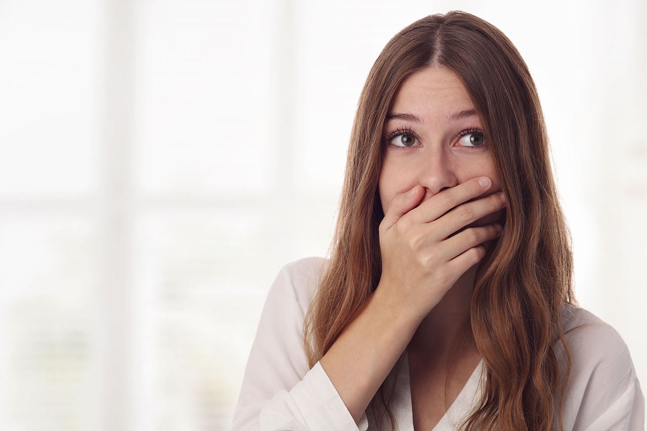 playful surprised shy young woman hiding