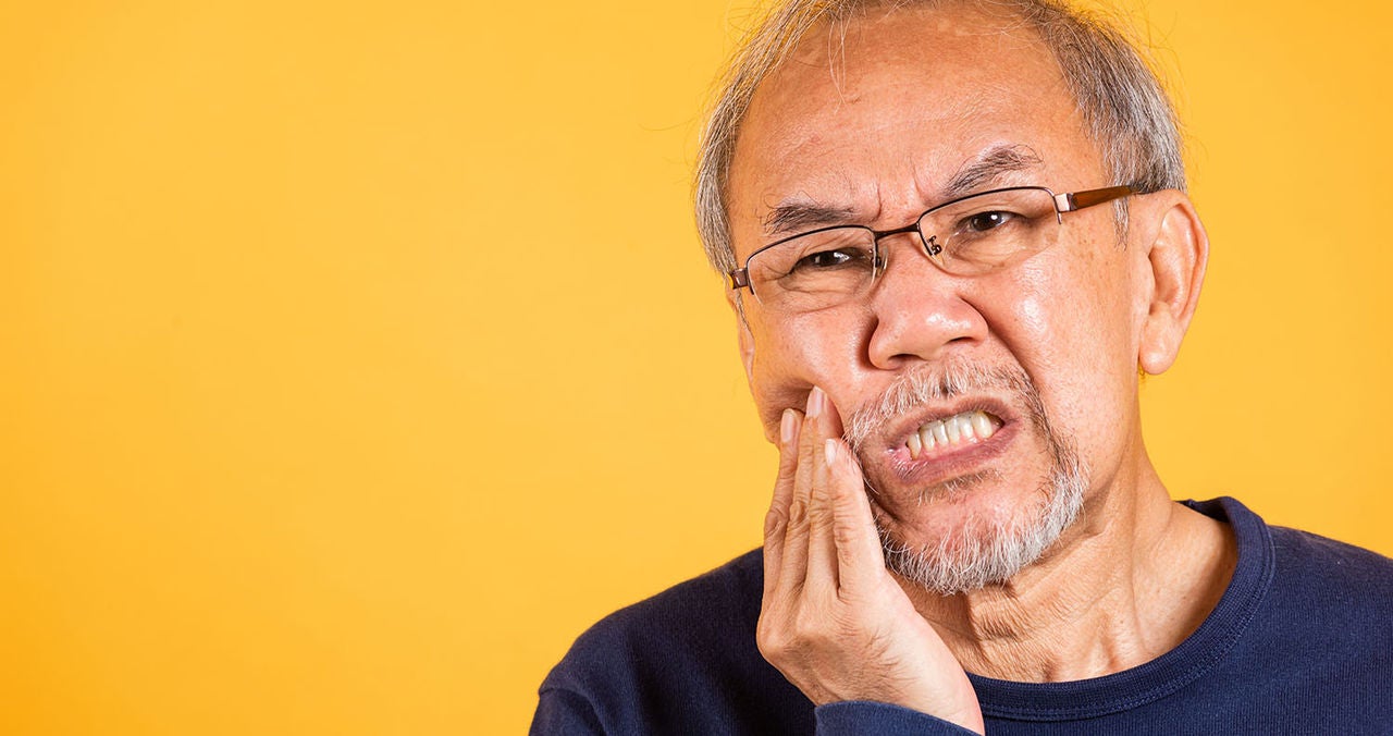 dental pain asian unhappy elder man
