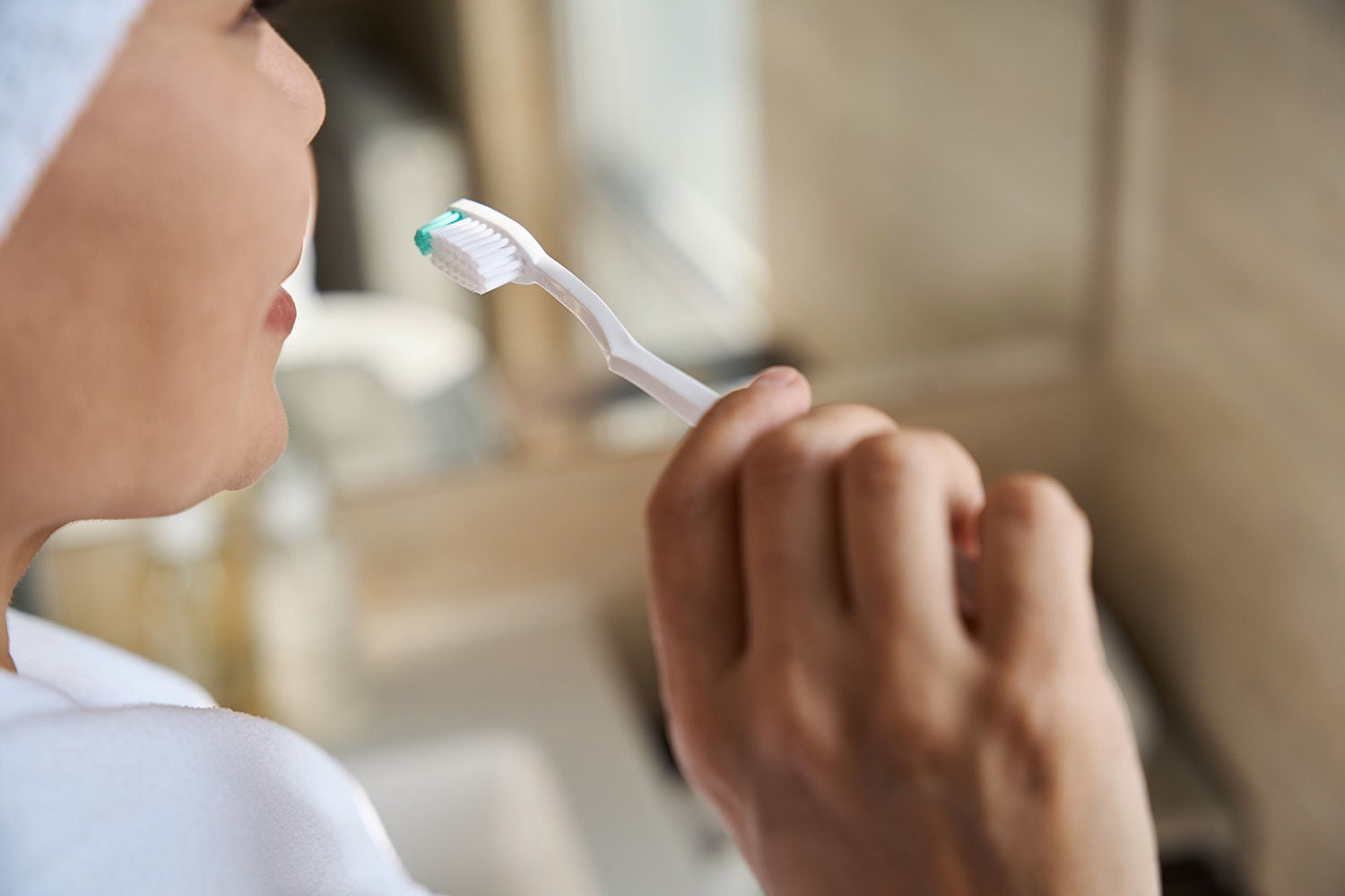 adult woman brushing her teeth bathroom
