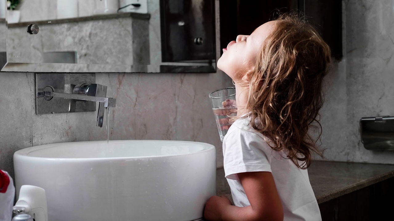 cute little curly child girl rinses