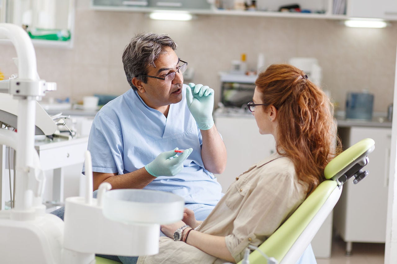 senior male dentist dental office talking